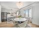 Kitchen and dining area with stainless steel appliances, marble countertops and decorative chandelier at 99 S Downing St # 605, Denver, CO 80209