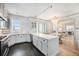 Modern white kitchen featuring stainless steel appliances and open to the dining area at 99 S Downing St # 605, Denver, CO 80209
