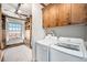 Functional laundry room features washer/dryer, wooden storage cabinets, and scenic view at 99 S Downing St # 605, Denver, CO 80209