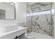 Bathroom featuring marble tile, a vessel sink, and a modern shower with a rainfall showerhead at 1100 Urban St, Lakewood, CO 80401