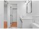 Bathroom featuring marble tile, a vessel sink, and access to a walk-in closet at 1100 Urban St, Lakewood, CO 80401