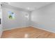 Bedroom featuring hardwood floors and two windows providing ample natural light at 1100 Urban St, Lakewood, CO 80401