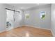Bedroom with hardwood floors and sliding door to marble-tiled bathroom and walk-in closet at 1100 Urban St, Lakewood, CO 80401
