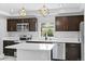 Modern kitchen features marble floors, white countertops, stainless steel appliances, and a large center island at 1100 Urban St, Lakewood, CO 80401