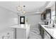 Modern kitchen featuring marble floors, white countertops, stainless steel appliances, and unique, modern lighting at 1100 Urban St, Lakewood, CO 80401