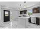 Stylish kitchen with stainless steel appliances, center island, and modern pendant lighting at 1100 Urban St, Lakewood, CO 80401