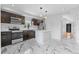 Modern kitchen with stainless appliances, sleek cabinets and eye-catching marble floors at 1100 Urban St, Lakewood, CO 80401