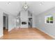 Spacious living room features hardwood floors and a fireplace, seamlessly flowing into the kitchen at 1100 Urban St, Lakewood, CO 80401