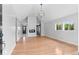 Bright open floor plan featuring hardwood floors and an eye-catching modern light fixture at 1100 Urban St, Lakewood, CO 80401