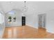 Sun-filled living room with hardwood floors, modern lighting, and a striking front door at 1100 Urban St, Lakewood, CO 80401