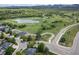 Aerial view of homes near a lake and golf course, highlighting the community's recreational amenities at 2807 S Nelson St, Lakewood, CO 80227