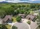 Aerial view of a suburban home on a cul-de-sac, nestled among lush greenery and mountain views at 2807 S Nelson St, Lakewood, CO 80227