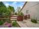 Landscaped backyard with garden bed, stone walkway, and wooden privacy fence at 2807 S Nelson St, Lakewood, CO 80227