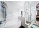 Luxurious bathroom features a tiled shower with glass door, a soaking tub, and modern fixtures at 2807 S Nelson St, Lakewood, CO 80227