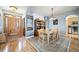 Open dining room featuring hardwood floors and a view into the entryway and kitchen at 2807 S Nelson St, Lakewood, CO 80227