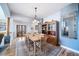 Charming dining room with a stylish chandelier, wood table, and hutch with hardwood floors and a neutral rug at 2807 S Nelson St, Lakewood, CO 80227