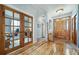 Charming entryway featuring hardwood floors and a stained glass accent over the front door at 2807 S Nelson St, Lakewood, CO 80227