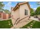 Exterior view of the home with a patio, stone ground cover, and well-maintained landscaping at 2807 S Nelson St, Lakewood, CO 80227