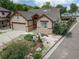 Charming single-Gathering home featuring a two-car garage, lush landscaping, and stone accents at 2807 S Nelson St, Lakewood, CO 80227