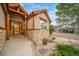 Close up view of the front of this home with a stone accent and a wood front door and frame at 2807 S Nelson St, Lakewood, CO 80227