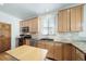 Modern kitchen with stainless steel appliances, granite countertops, light wood cabinets, and ample counter space, ideal for cooking at 2807 S Nelson St, Lakewood, CO 80227