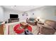 Cozy living room with a modern entertainment center, soft seating, and a patterned rug at 2807 S Nelson St, Lakewood, CO 80227