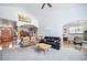 Open-concept living room featuring vaulted ceilings, archways, hardwood floors, and ample natural light, great for entertaining at 2807 S Nelson St, Lakewood, CO 80227