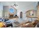 Inviting living room showcasing a fireplace, vaulted ceiling, archway details, and lots of natural light, ideal for gathering at 2807 S Nelson St, Lakewood, CO 80227