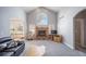 Bright living room with fireplace, vaulted ceiling, and large arched windows, offering a cozy and inviting atmosphere at 2807 S Nelson St, Lakewood, CO 80227