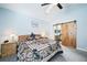 Comfortable bedroom with a sliding barn door leading into an ensuite bath for added privacy at 2807 S Nelson St, Lakewood, CO 80227