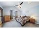 Relaxing bedroom featuring vaulted ceiling, ceiling fan, two windows, and two bedside tables with lamps at 2807 S Nelson St, Lakewood, CO 80227