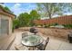 Patio area with outdoor dining table, chairs, and stone retaining wall in the backyard at 2807 S Nelson St, Lakewood, CO 80227