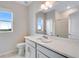This bright bathroom features a white vanity and a large mirror at 24851 E 33Rd Dr, Aurora, CO 80019