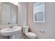 Well-lit bathroom features a pedestal sink, modern fixtures, and a window for natural light at 24851 E 33Rd Dr, Aurora, CO 80019