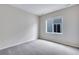 This bedroom features soft gray walls, neutral carpet, and a bright window at 24851 E 33Rd Dr, Aurora, CO 80019