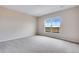 Carpeted bedroom features a large window with scenic views offering plenty of natural light at 24851 E 33Rd Dr, Aurora, CO 80019