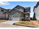 Contemporary two-story home with a gray exterior, attached garage, and well-kept lawn at 24851 E 33Rd Dr, Aurora, CO 80019