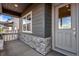Inviting front porch featuring stone accents and a stylish front door at 24851 E 33Rd Dr, Aurora, CO 80019