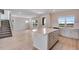 Modern kitchen featuring a center island, stainless appliances, and an adjacent staircase at 24851 E 33Rd Dr, Aurora, CO 80019