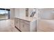 Open concept kitchen with white cabinets, a center island, and adjacent staircase at 24851 E 33Rd Dr, Aurora, CO 80019