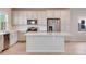 Bright kitchen featuring white cabinets, stainless steel appliances, and a large center island at 24851 E 33Rd Dr, Aurora, CO 80019