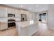 Bright kitchen featuring white cabinets, stainless steel appliances, and a large center island at 24851 E 33Rd Dr, Aurora, CO 80019