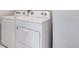 This laundry area includes a white Whirlpool washer and dryer at 24851 E 33Rd Dr, Aurora, CO 80019