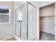 Bathroom features a glass shower, large window, and acces to the walk-in closet at 24851 E 33Rd Dr, Aurora, CO 80019