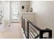 Well-lit hallway with a door leading to a balcony and decorated with art at 8240 E 36Th Ave # 33, Denver, CO 80238