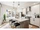 Modern kitchen featuring an island with seating, stainless steel appliances, white cabinets, and contemporary pendant lighting at 8240 E 36Th Ave # 33, Denver, CO 80238