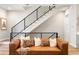 Cozy living room showcases a staircase with iron railings and comfortable seating at 8240 E 36Th Ave # 33, Denver, CO 80238