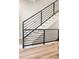 Modern staircase with black metal railing and light-colored carpet at 8240 E 36Th Ave # 33, Denver, CO 80238