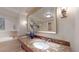 A luxurious bathroom with marble countertops, dual sinks, a soaking tub, and stylish fixtures at 1891 Curtis St # 1613, Denver, CO 80202