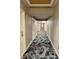 Long hallway featuring decorative patterned carpeting and wallpaper leading to various rooms at 1891 Curtis St # 1613, Denver, CO 80202
